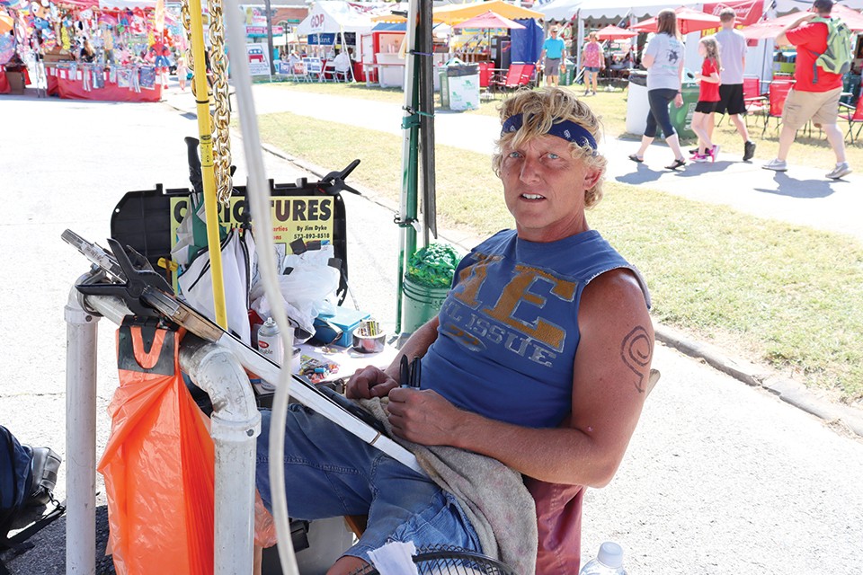 Jim Dyke takes a vacation from his day job every year to paint caricatures at the Missouri State Fair, where his running commentary is as entertaining as his artwork. - JAMES POLLARD