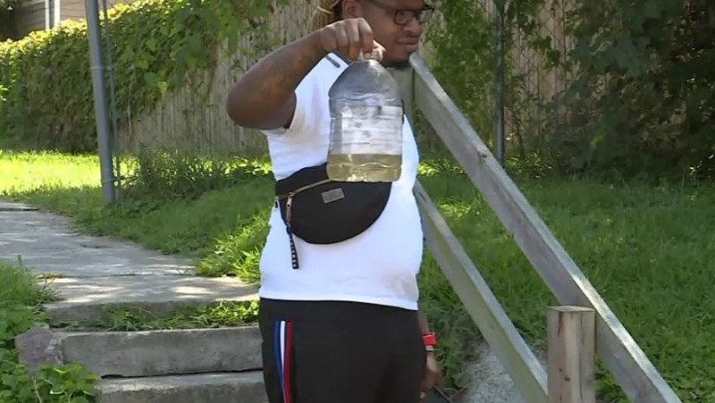 Lamar Conner holds up a bottle of gasoline he says was used in a terrifying home invasion. - SCREENSHOT VIA FOX 2