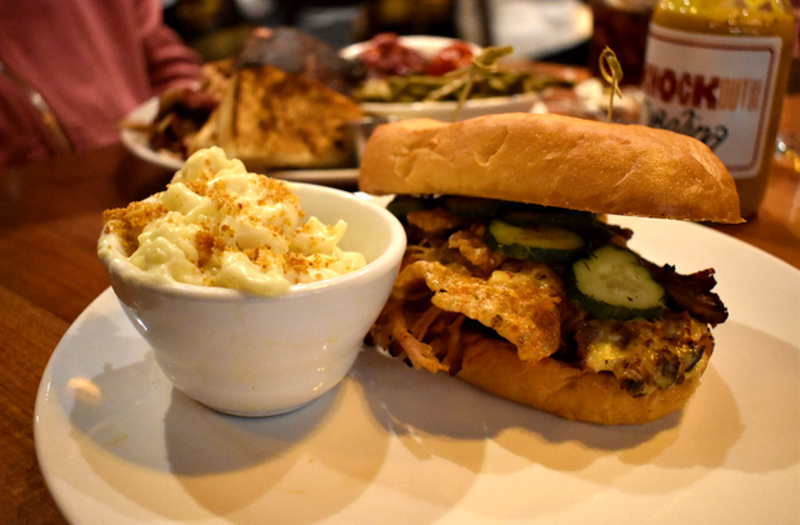 Loaded pulled pork sandwich with chicharrones, sweet pickles, Texas sauce and queso plus mac 'n' cheese. - Liz Miller