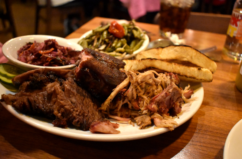 A combo plate with pulled pork, brisket and ribs with tangy slaw and roasted green beans with tomatoes. - LIZ MILLER