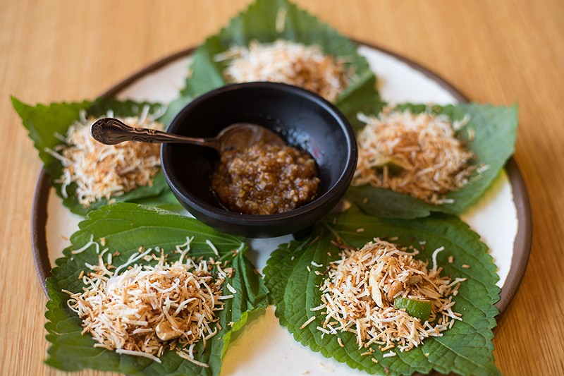 Mieng kham tops green leaf wraps with dried shrimp, ginger, lime, onion, chile and toasted coconut with a tamarind dipping sauce. - MABEL SUEN