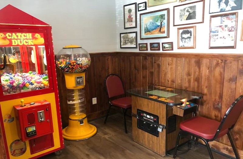 There's an old-school Catch a Duck claw game and retro Ms. Pac-Man game in the back of the dining room. - Liz Miller