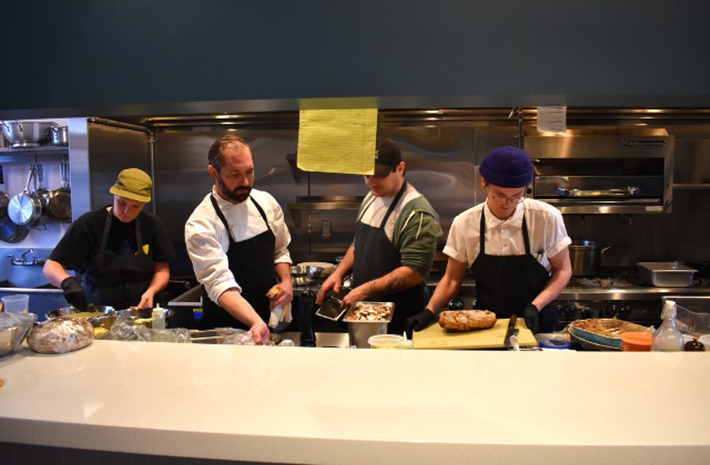 Chef-owner Craig Rivard (pictured second from left) working in the kitchen with his team. - Liz Miller