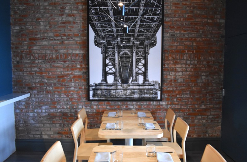 Artwork of the Brooklyn Bridge hangs in the dining room as an homage to the Rivards' history. - LIZ MILLER
