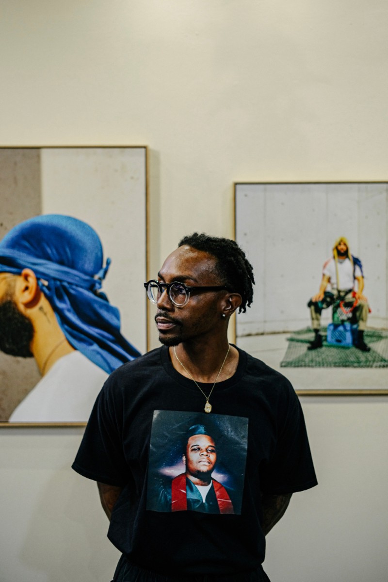 Adrian wearing a T-shirt featuring Michael Brown's high school graduated photo taken at The Greens gallery in Columbia, Missouri. - Courtesy Adrian Walker