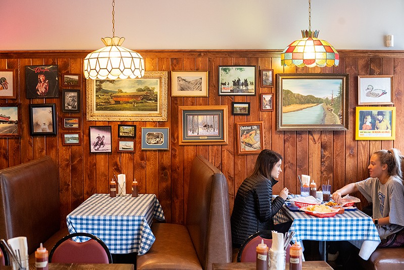 Vintage stained-glass chandeliers that appear fogged from years of smoke hang from the ceiling at Original J’s, while framed pictures of waterfowl and Waylon Jennings decorate the dining room. - MABEL SUEN