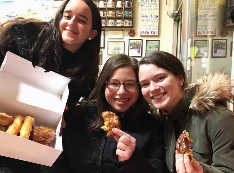 Dia Villegas, Carly Hacker, and Emmat St. Raymond chow a haul of late-night John's Donuts. - Photo courtesy of Carly Hacker