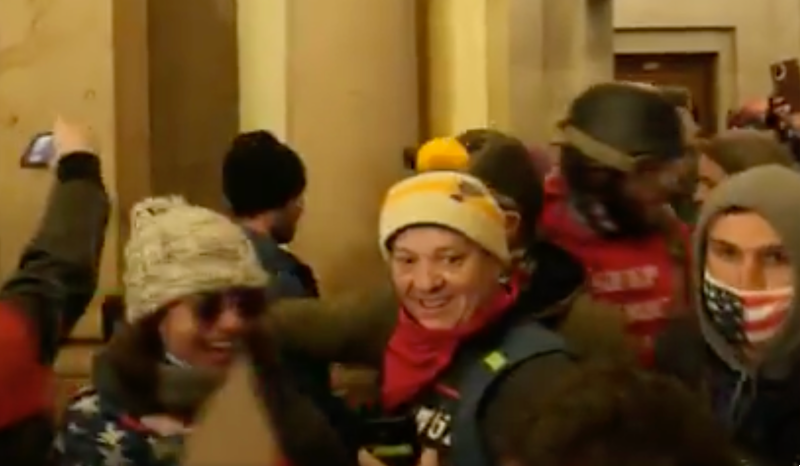 A grinning Paul Westover, center, next to Emily Hernandez, left. - ITV NEWS SCREENSHOT