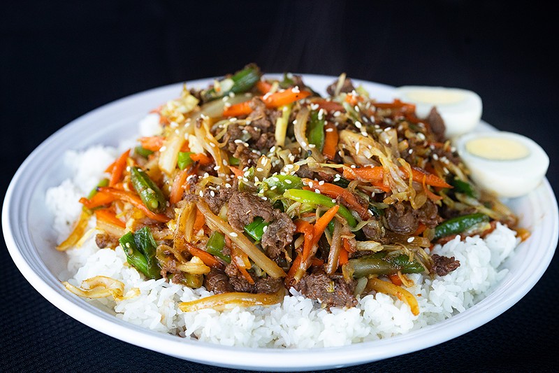 Bulgogi beef bowl with marinated beef, onion, carrot, scallion, green bean and cabbage, served over steamed rice with a boiled egg. - MABEL SUEN
