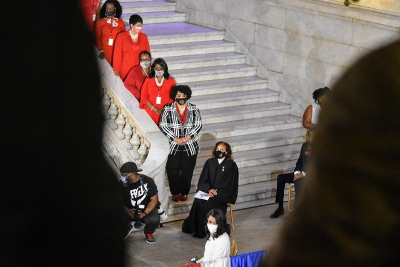 Tishaura Jones waits to be sworn in while her Delta Sigma Theta sisters in red stand in support. - DOYLE MURPHY