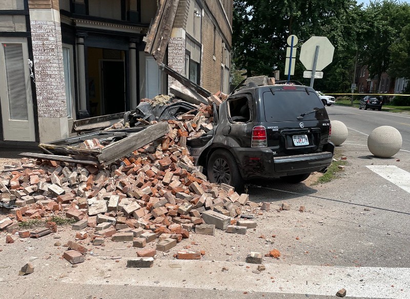 The SUV was mashed below a pile of bricks that fell off the building. - ST. LOUIS FIRE DEPARTMENT TWITTER