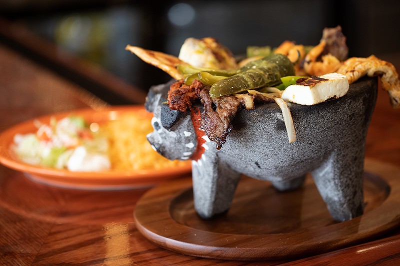Molcajete with beef, chicken, shrimp, cactus, bell pepper, onion, chiles toreados, chorizo, tomato, queso panela, rice, beans and tortillas. - MABEL SUEN