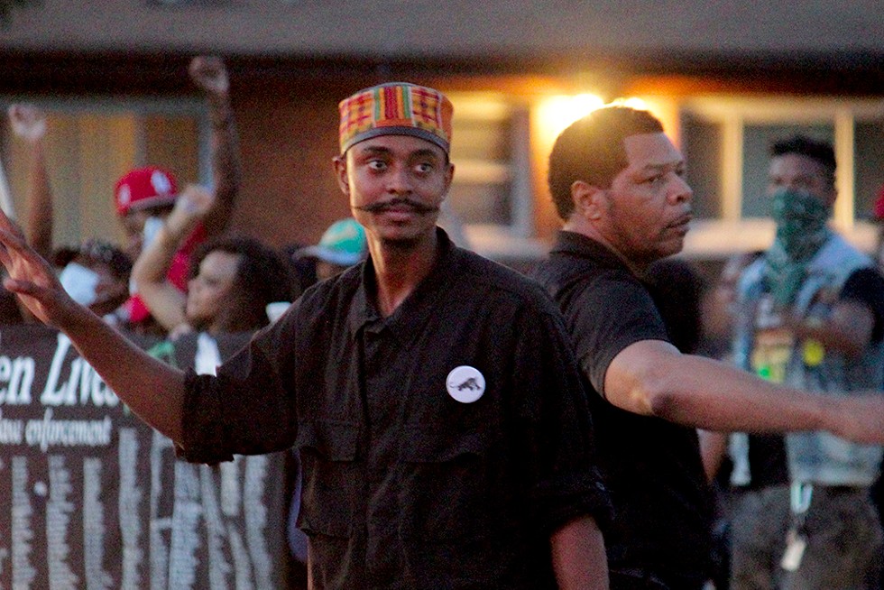 In this image from August 14, 2014, Davis and other members of the New Black Panthers helps direct traffic during a demonstration. - DANNY WICENTOWSKI