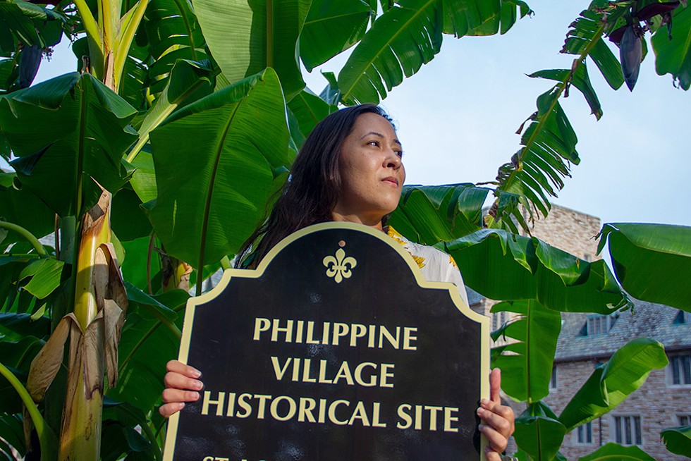 In Concordia Seminary, on the edge of what used to be the Philippine Village, Langholz displays the sign she carries during tours of the site -- a temporary marker, for now. - DANNY WICENTOWSKI