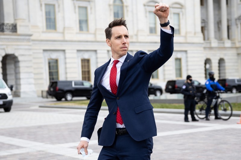Sen. Josh Hawley (R-Mo.) gestures toward a crowd of supporters of President Donald Trump gathered outside the U.S. Capitol to protest the certification of President-elect Joe Biden's electoral college victory on Jan. 6, 2021. Some demonstrators later breached security and stormed the Capitol. - FRANCIS CHUNG/COURTESY OF E&E NEWS AND POLITICO