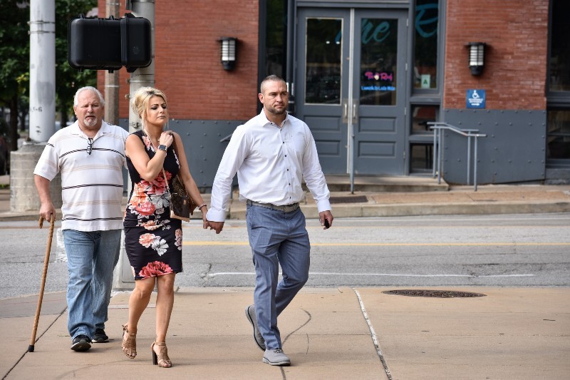 Dustin Boone, right, walks to the federal courthouse in St. Louis with his family. - DOYLE MURPHY