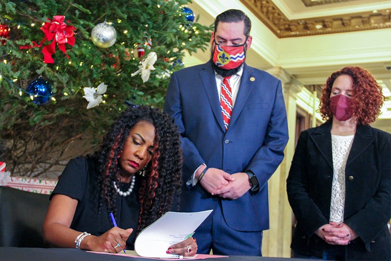 Alderpersons Bret Narayan and Annie Rice look on as St. Louis Mayor Tishaura signs a marijuana decriminalization bill into law on December 13. - DANNY WICENTOWSKI
