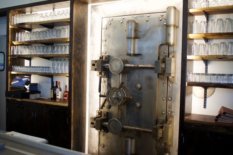 A safe, located behind the bar, reminds guests of the building's history as a bank. - CHERYL BAEHR