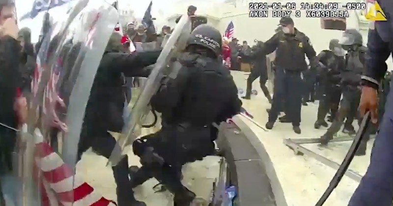 Rioters knock a police officer to the ground on January 6, 2021, at the U.S. Capitol, as captured on a police body cam. - DEPARTMENT OF JUSTICE