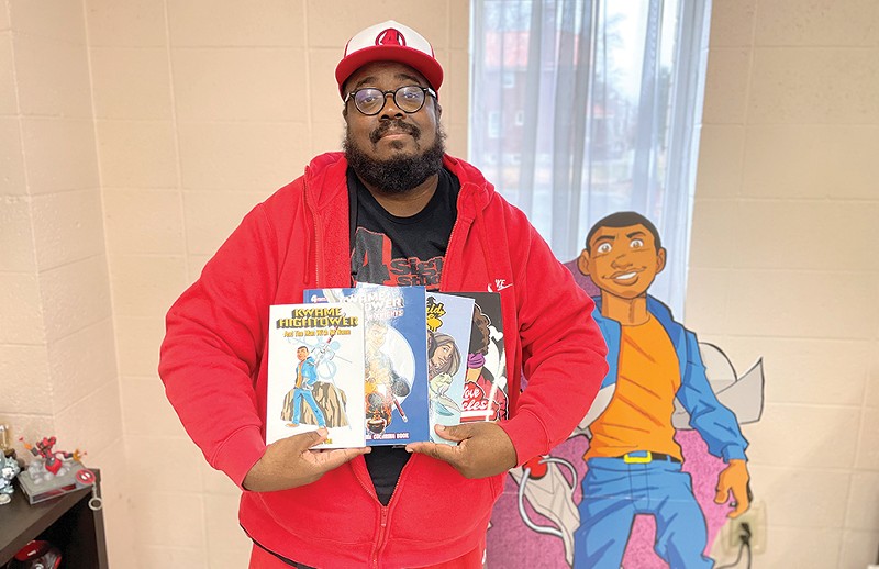 David Gorden poses with a selection of comics he's released to date. - JACK PROBST