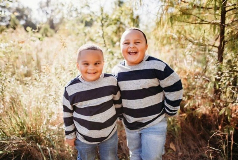 Isaiah Taylor, left, stands next to his brother Elijah Taylor, right, for a photograph in 2021. Isaiah was diagnosed with cancer on Jan. 24, 2019. - CLUMSY HEART PHOTOGRAPHY