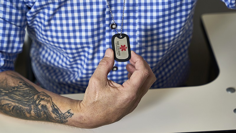 A dog tag Daniel Coverdell wears telling emergency responders he is on naltrexone, since the treatment drug makes him resistant to opioid pain relievers. - THEO WELLING