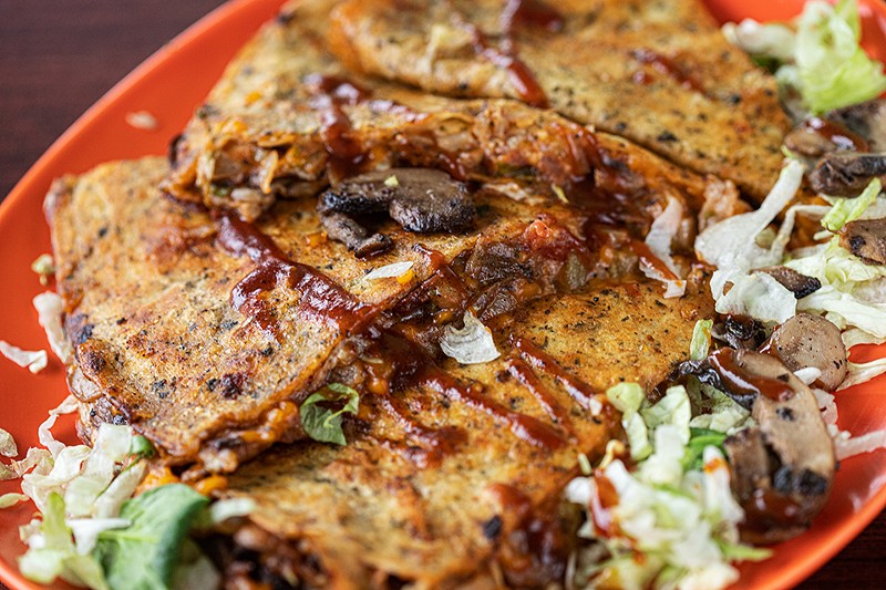 The mushroom quesadilla is filled with grilled mushrooms, vegan bacon, and plant-based cheese and sour cream. - MABEL SUEN