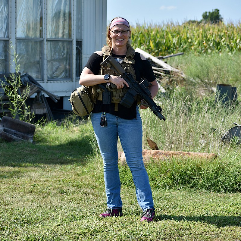 Tricia Neher poses with her gun. - Reuben Hemmer