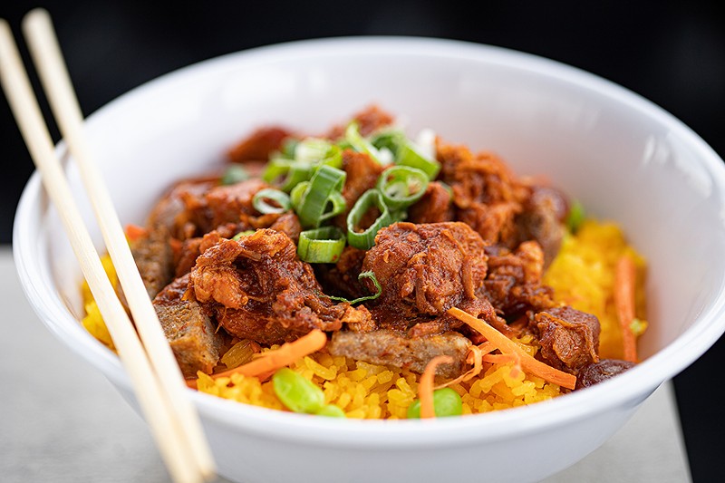 "Asian Paella" features pork carnitas, jasmine rice with Sazon seasoning, Chinese sausage, mild sausage and edamame. - Mabel Suen