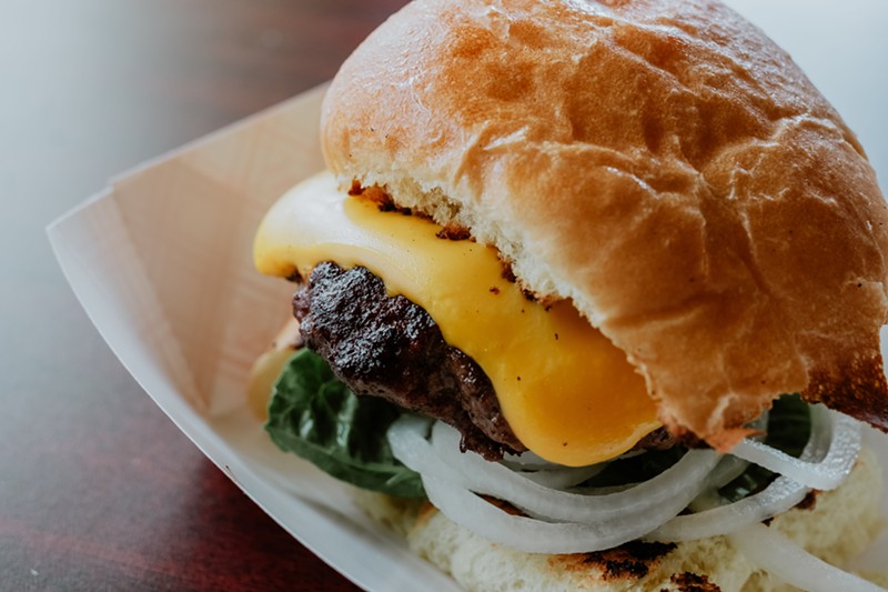 the "Hank Burger," cooked on a vintage grill just behind the bar, is the Iowa Buffet's signature dish.  - PHUONG BUI