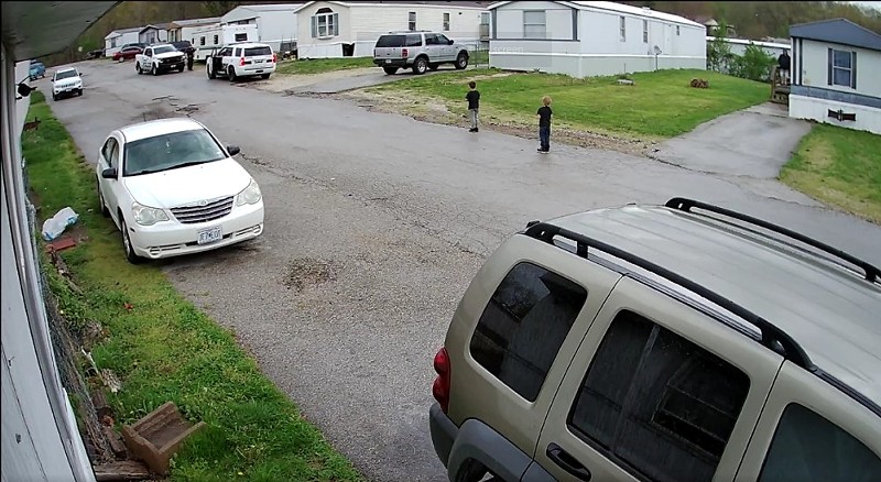 Home security footage shows children running after officers shot a dog nearby. - Screengrab from Reddit