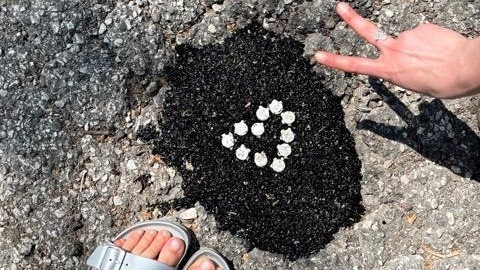 A tiled heart embedded in the asphalt. - COURTESY JAMISON FORD