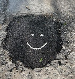 The secret to DIY pot hole repair is pre-made asphalt, Ford says. - COURTESY JAMISON FORD