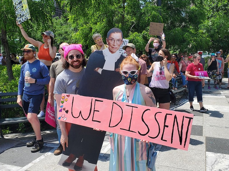 (From left) Ryan Cooper and Emily (last name withheld) brought a cut out of Ruth Bader Ginsburg to the abortion rights protest. - ROSALIND EARLY