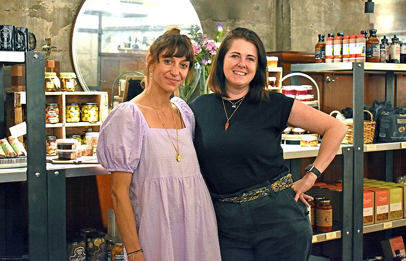 Kara Flaherty, the beverage and retail director for Take Root Hospitality, (right) runs The Cellar Shop at Winslow's Table alongside Mia Kannapell (left). - Jessica Rogen