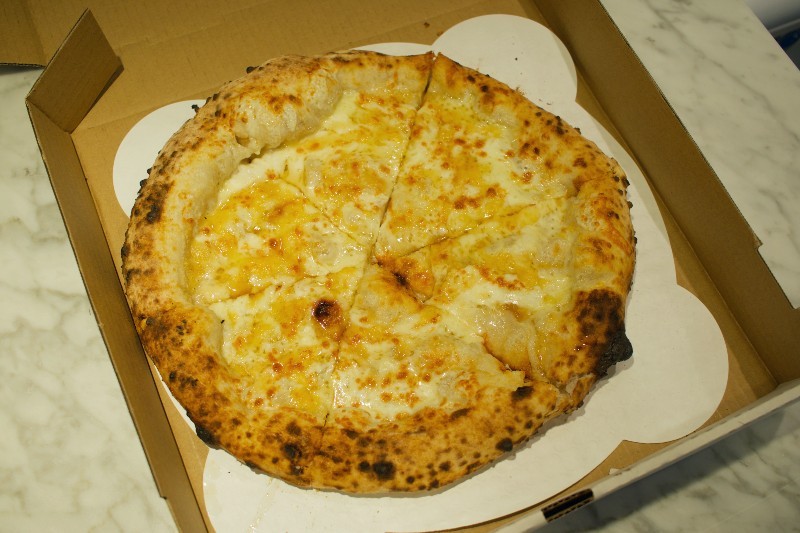 Fordo's four cheese pizza is a blend of mozzarella, tallegio, fontina and parmesan. - CHERYL BAEHR
