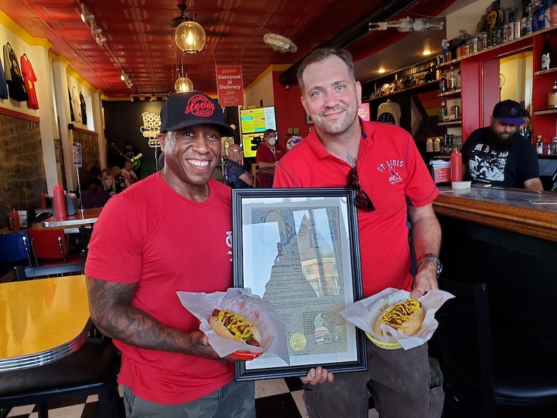 Founder and co-owner of Steve's Hot Dogs and Burgers, Steve Ewing, and Chef Joseph Zeable with the St. Louis-Style dog and the resolution from the City of St. Louis, making it the city's official hot dog. - ROSALIND EARLY