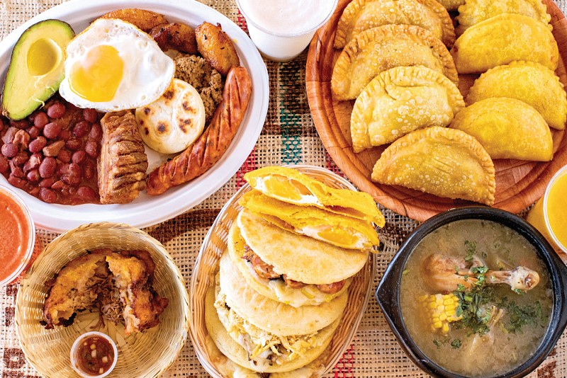 Maize & Wheat's (clockwise from top left) bandeja paisa, coconut lemonade, empanadas, mango juice, sancocho, arepas, stuffed potato and guava juice. - Mabel Suen