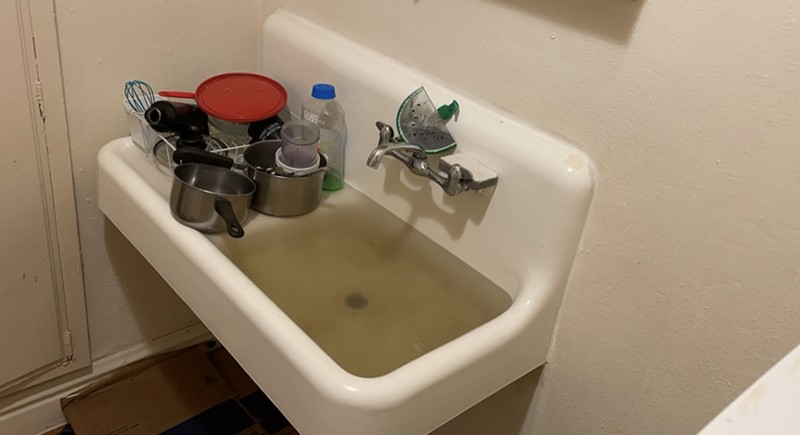 A sink overflowing in the Raphael Apartments. - VIA ALEX