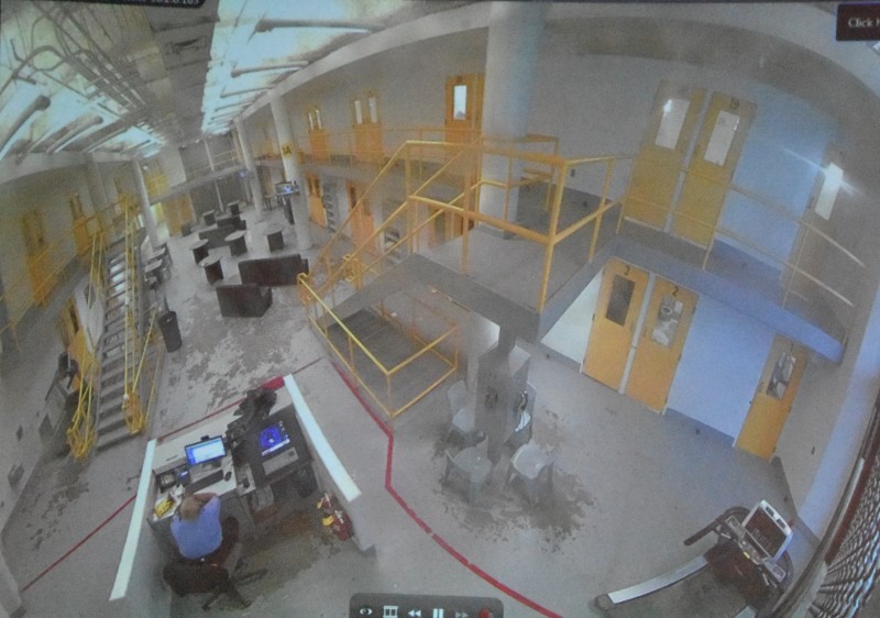 A photo of the surveillance camera monitor shows the inside of the City Justice Center.