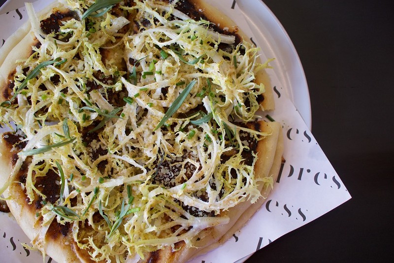 The potato pizza features beer cheese, fontina, rosemary, mustard and frisée.