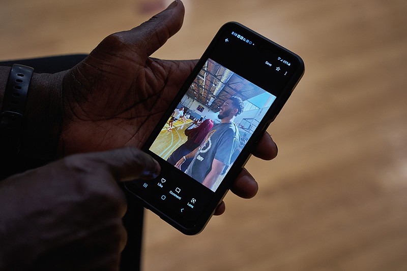 Nettles shows an image on his phone of Jayson Tatum visiting Wohl Center. The NBA star grew up coming to Wohl and now supports the center. - THEO WELLING