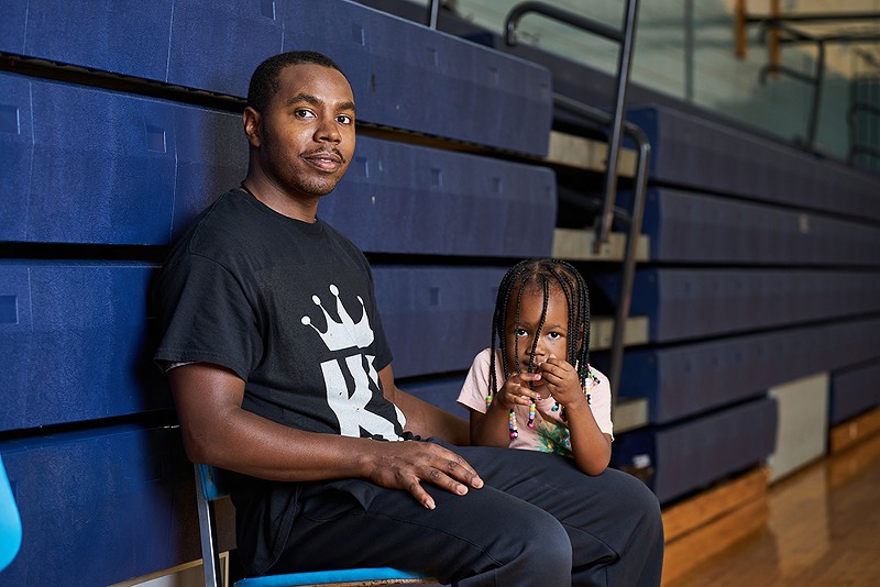 Volunteer coach Stephon King sits on the sidelines at Wohl with Auria, his daughter. - THEO WELLING