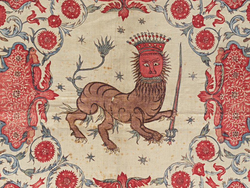 A painted design of an animal like a tiger with a crown.