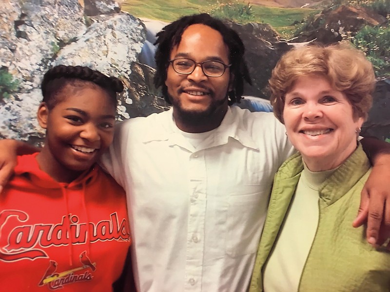 Khorry Ramey (left) and Kevin Johnson (center) maintain a close relationship with Johnson's elementary school principal Pamela Stanfield (right).