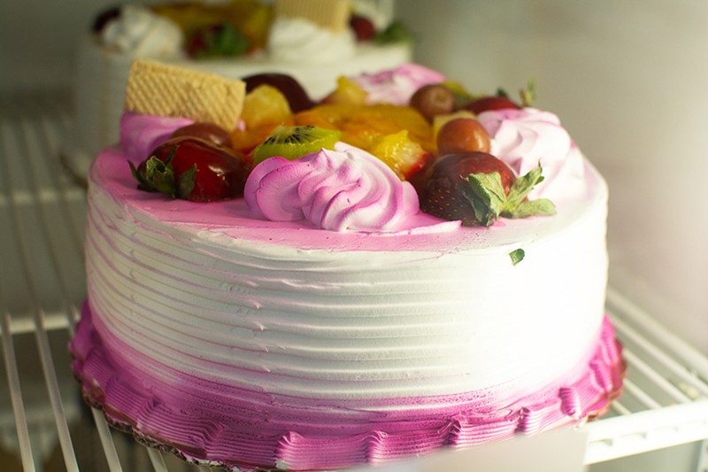 A cake topped with fruit.