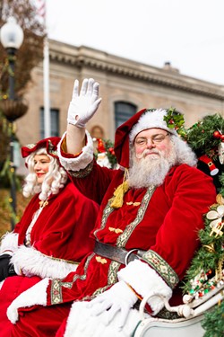 Santa Claus waving to the crowd.