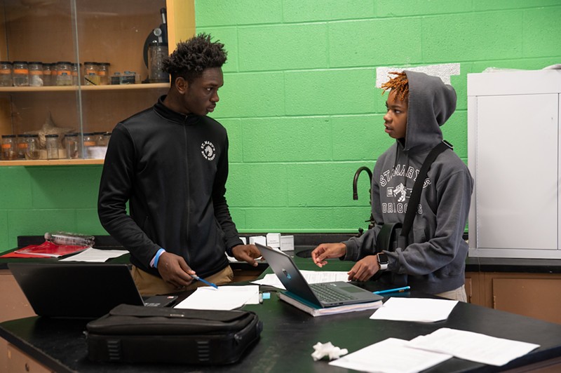 From left: David Leonard, St. Mary's starting quarterback and Myles Hawkins discuss work in class.