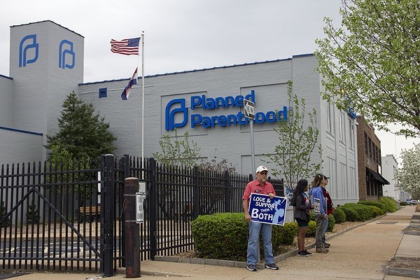 A protester stands outside Planned Parenthood.