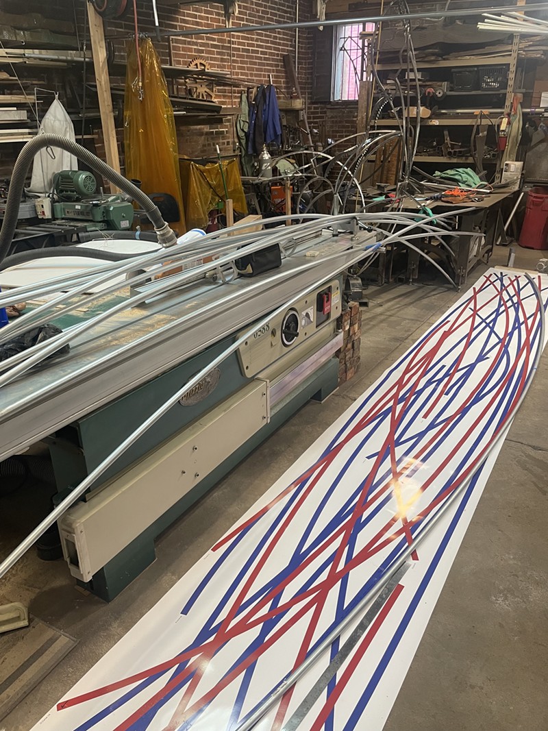 A 20-foot template of red and blue wavy lines in a workspace.